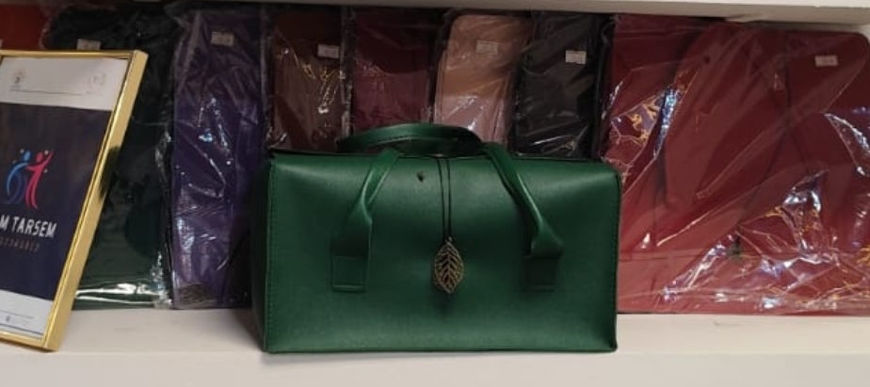 Picture of The multi-use leather bag is available in orange, olive, pink, and purple. Green, Red, Brown